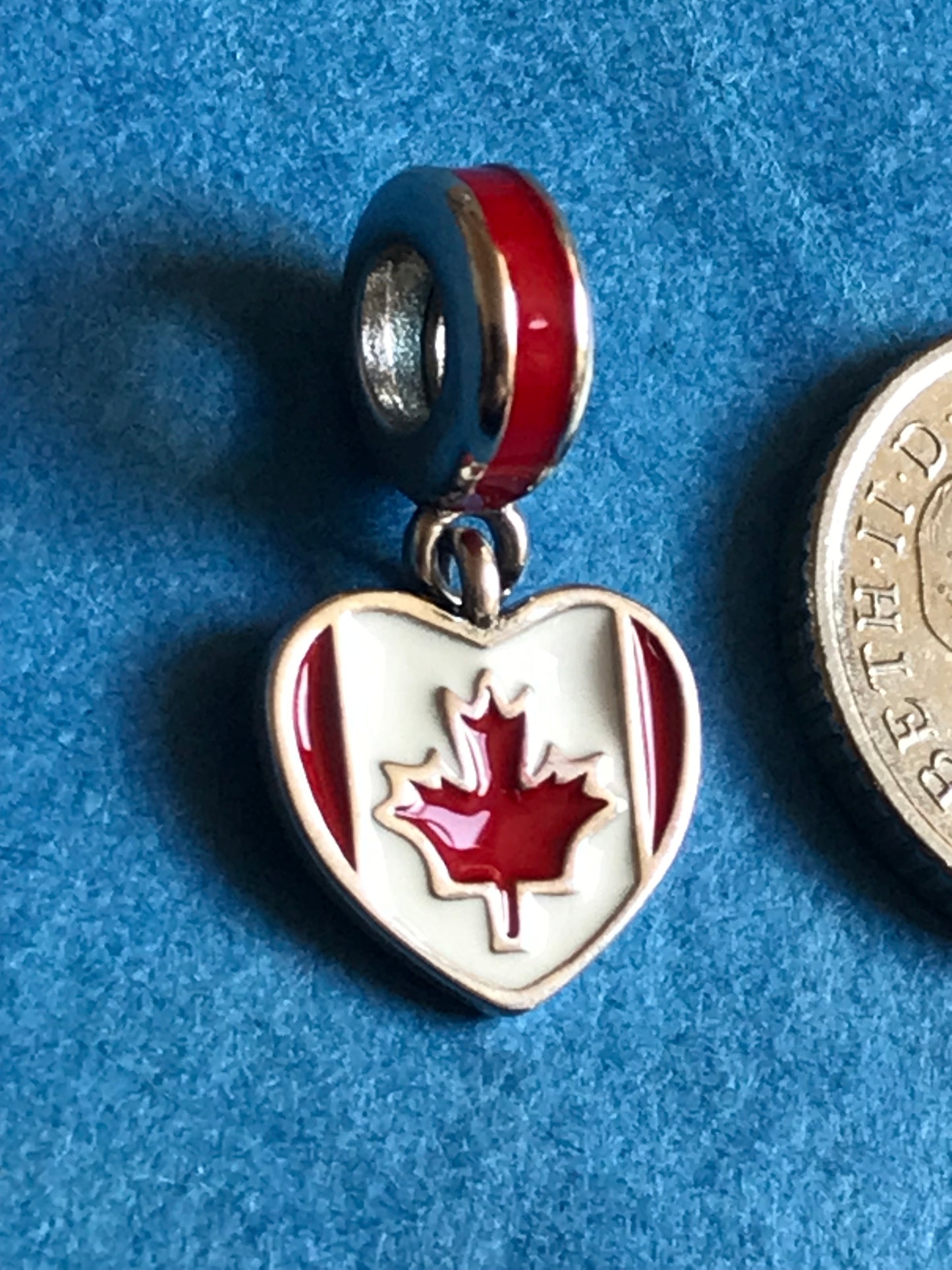 Genuine 925 Silver Canada Charm with a maple leaf design on a blue background