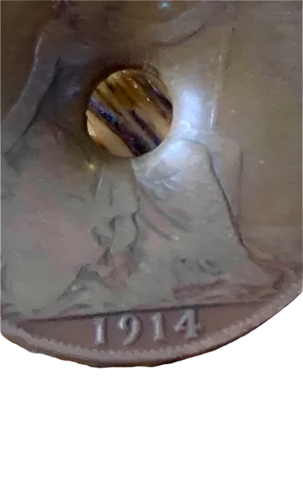 World War One Dated 1914 Coin damaged by Shrapnel on a white background
