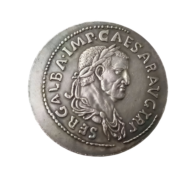 Ancient silver coin with engraved face and inscriptions on a white background