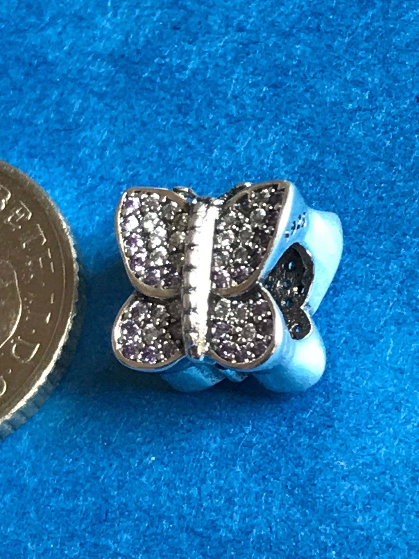 Butterfly-shaped charm with sparkling details on a blue background for charm bracelet 925 silver