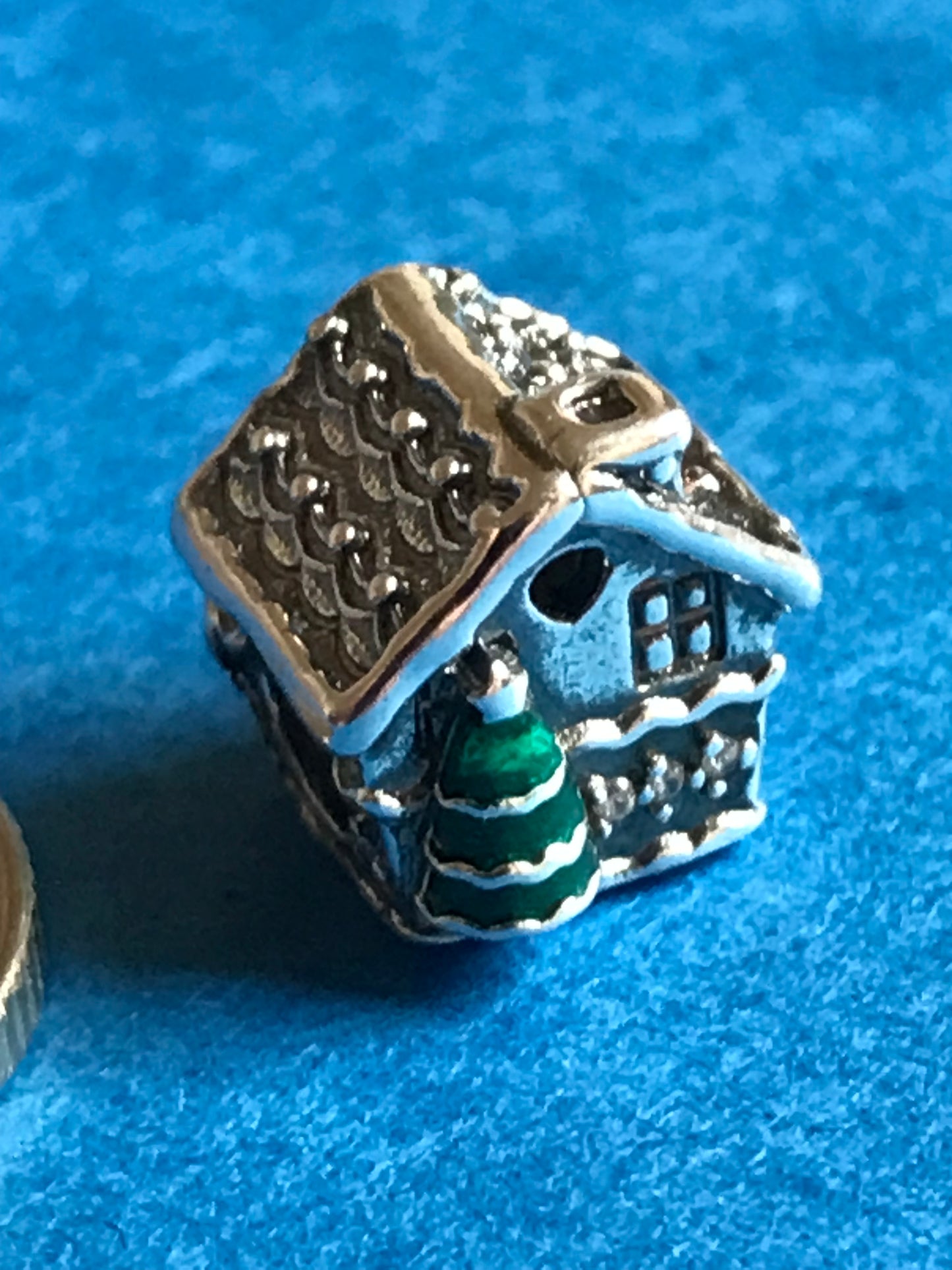 Silver Christmas House charm on a blue background for charm bracelet