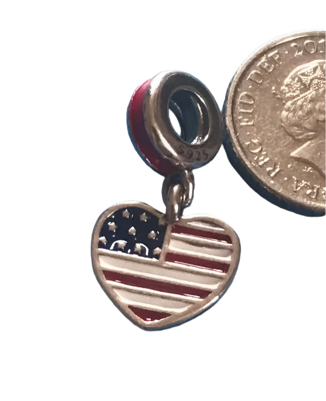 Heart-shaped American flag charm next to a British coin on a white background USA 925 Silver fit Pandora