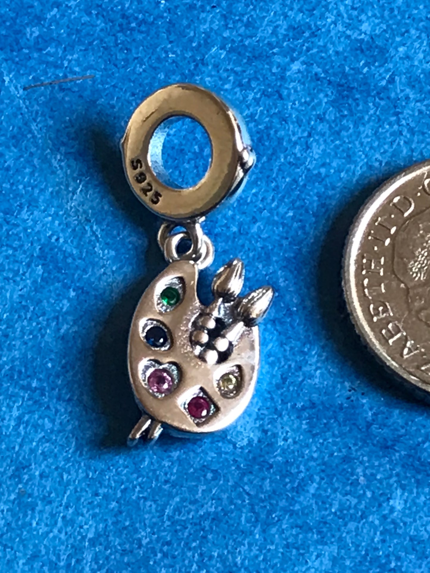 Genuine 925 Silver Artist Palette charm with colored stones on a blue background for charm bracelet 925 silver