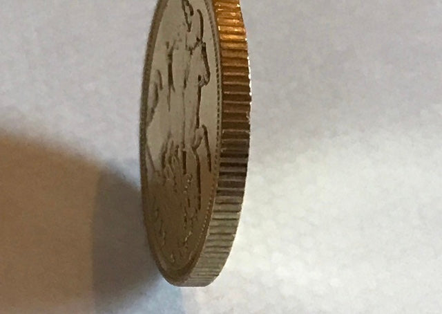 Close-up of a gold coin on a white background