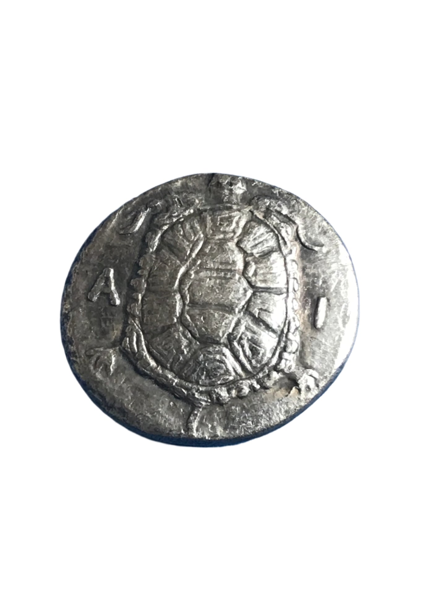 Silver coin with embossed design on a white background