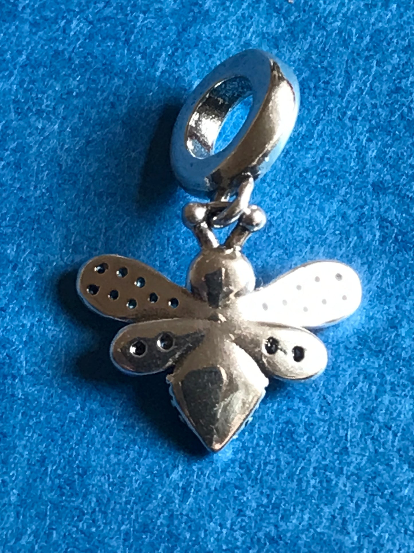 Genuine 925 Silver Bee Charm on a blue background