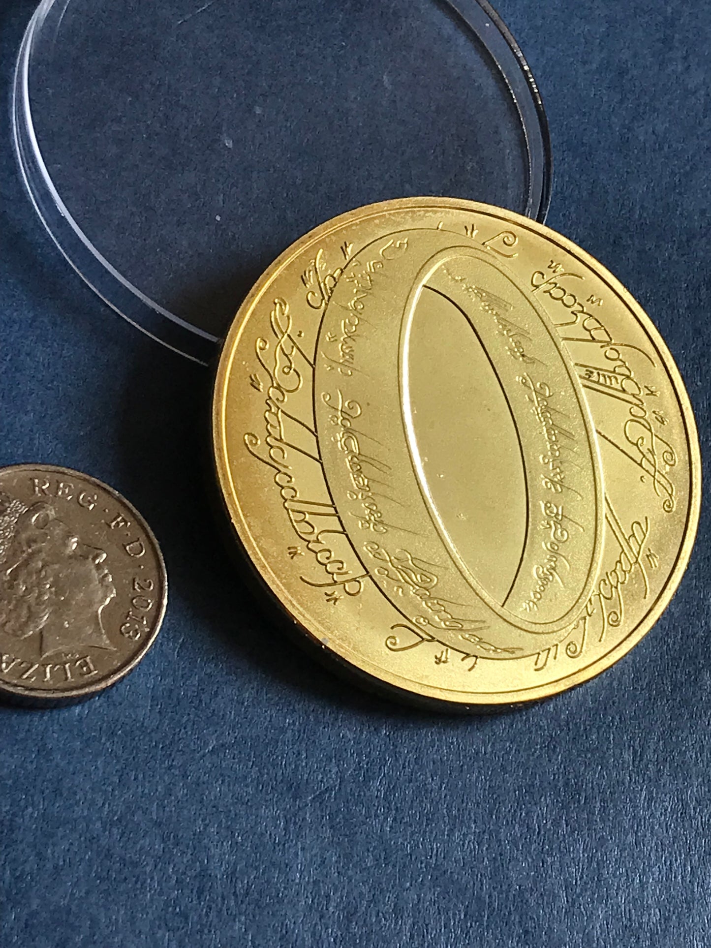 Gold coin with engraved text on a blue background