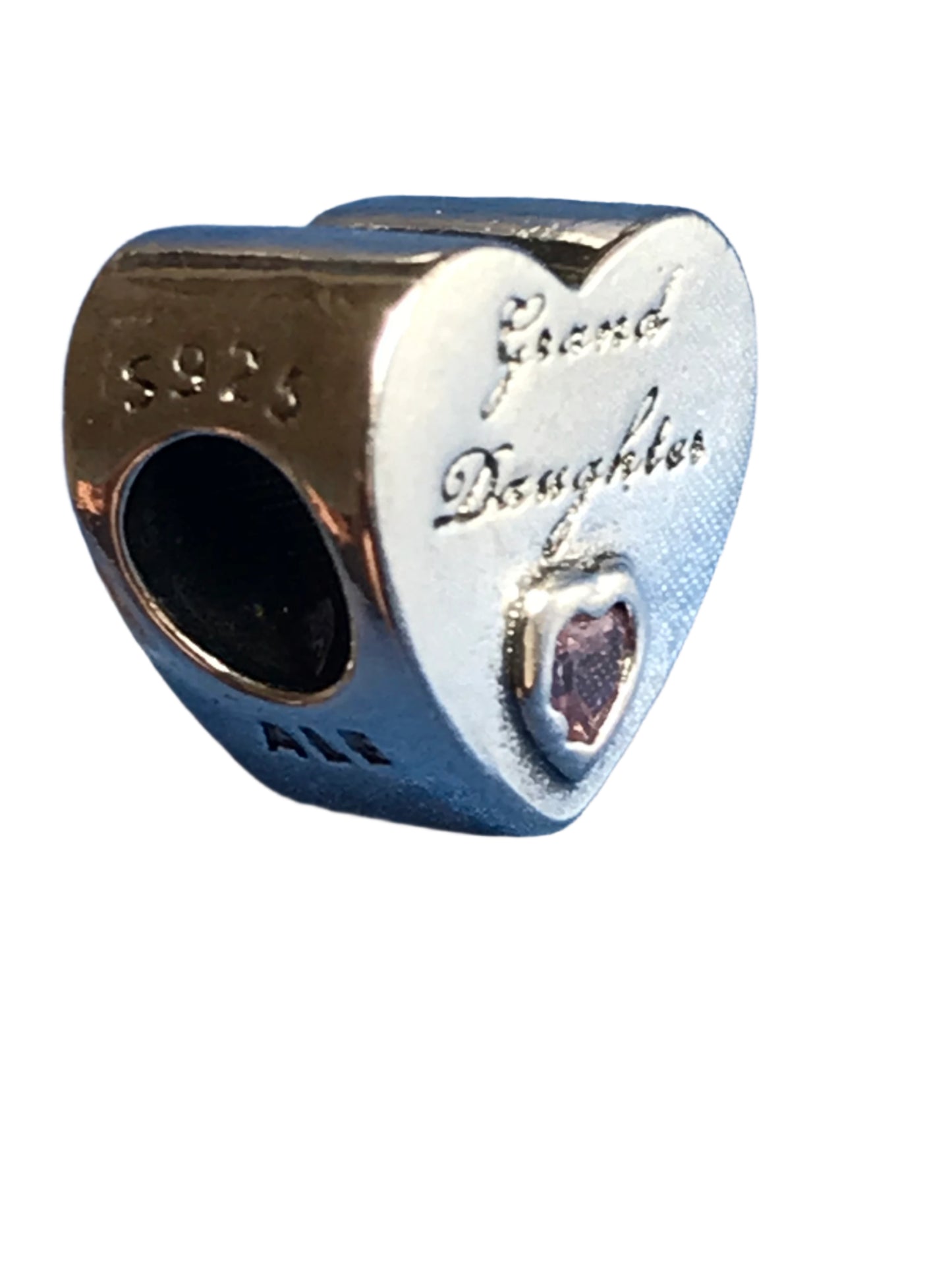 Heart-shaped silver charm with 'Granddaughter' engraving on a white background