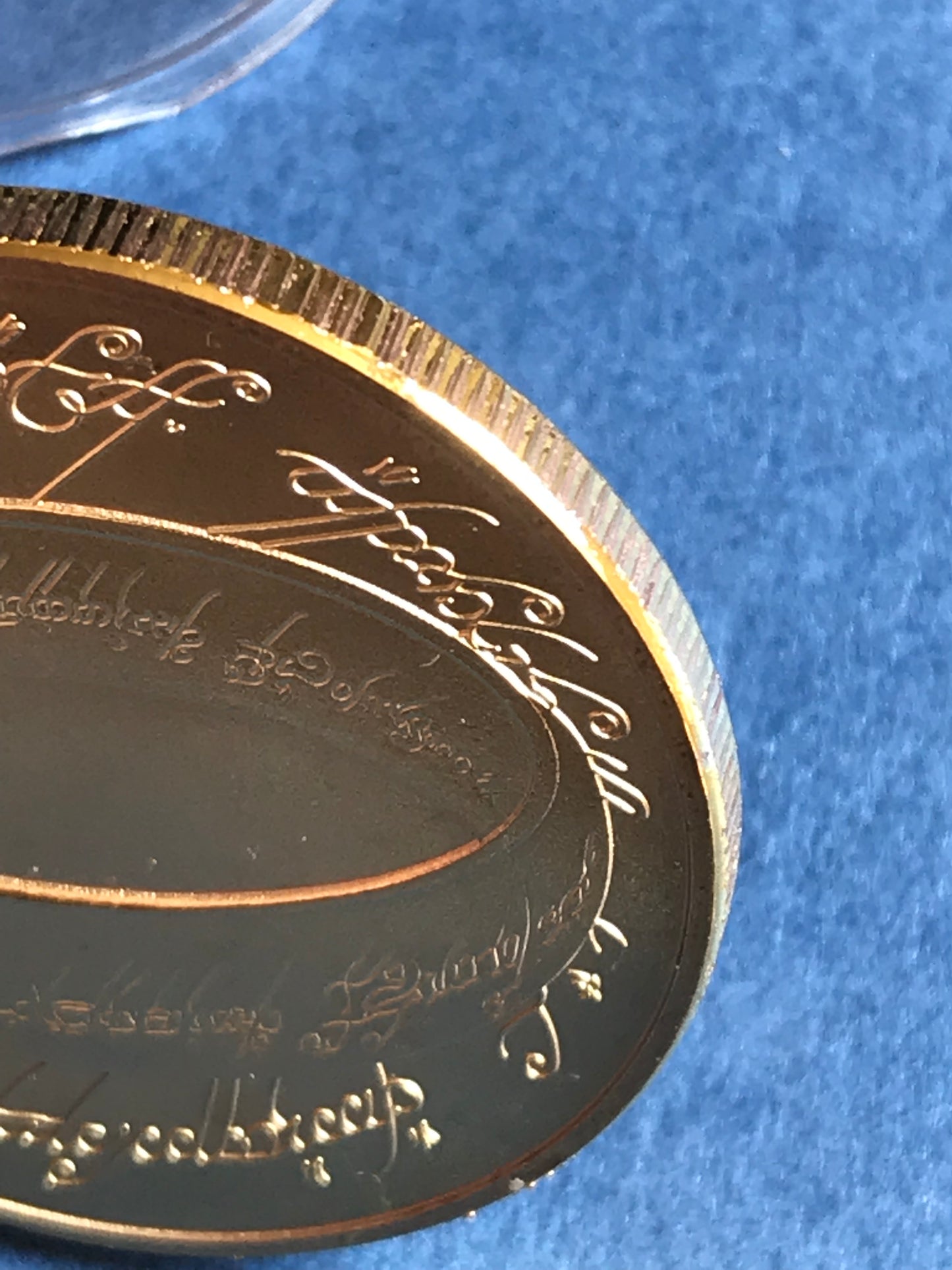 New Lord of the Rings coin with engraved text on a blue background