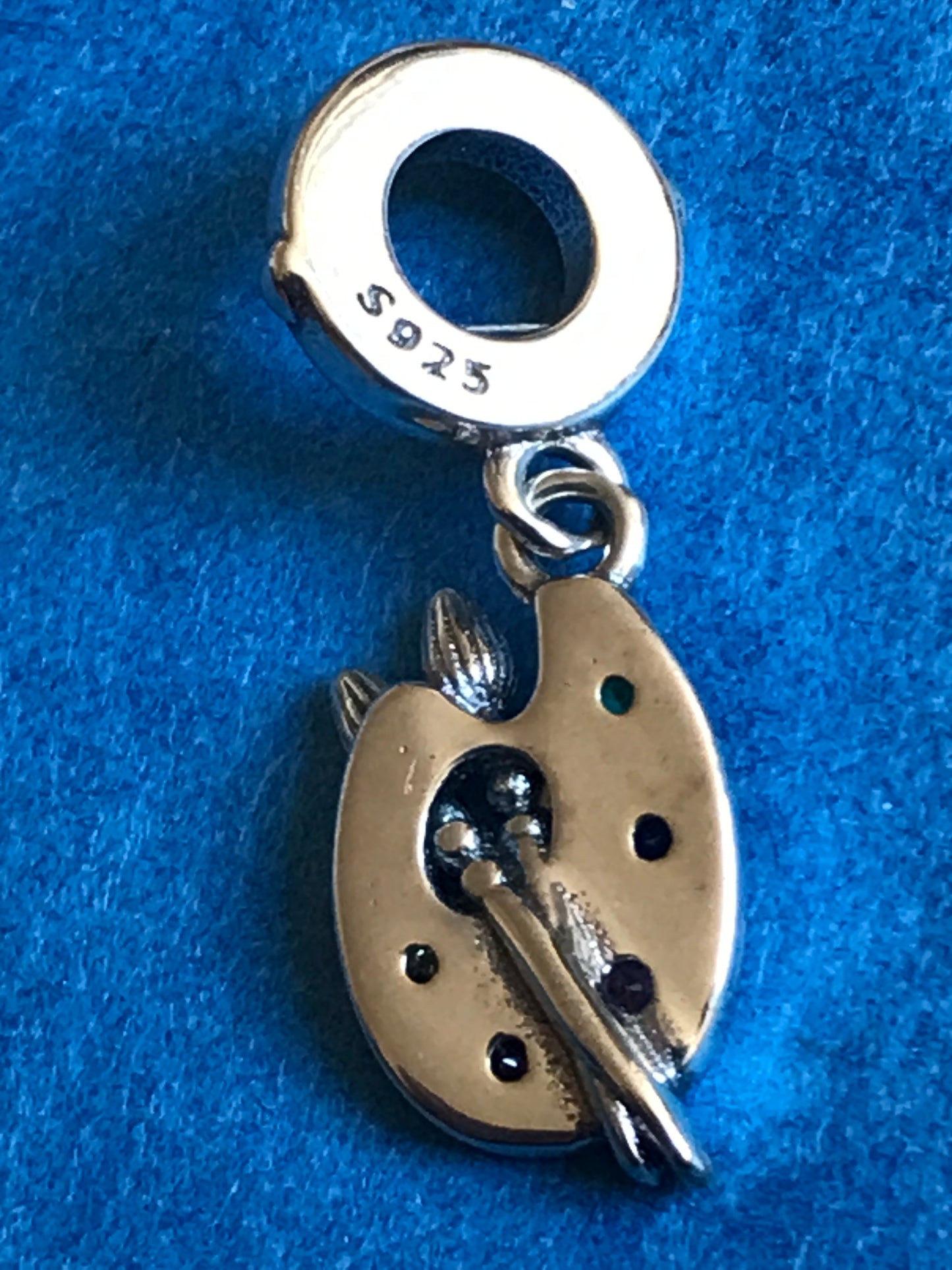Genuine 925 Silver Artist Palette charm on a blue background