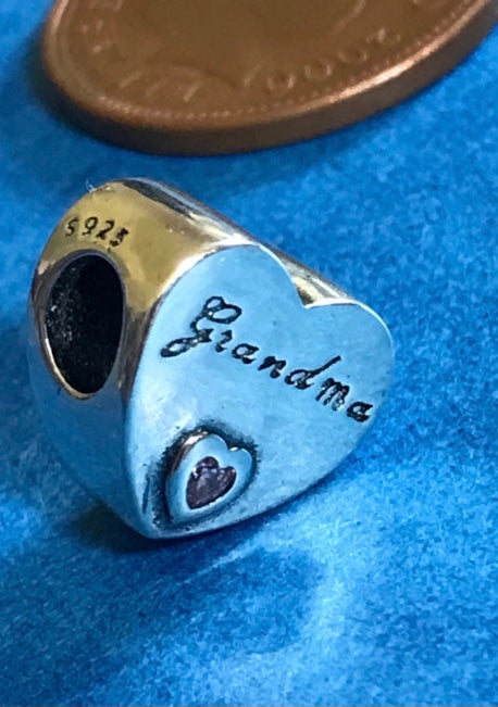 Heart-shaped charm with 'Grandma' engraving on a blue background for bracelet 