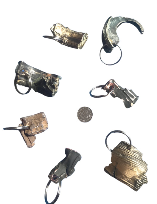 World War Two Battle of Britain Shrapnel key chains on a white background