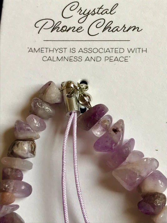 Crystal phone charm with amethyst stones on a white background