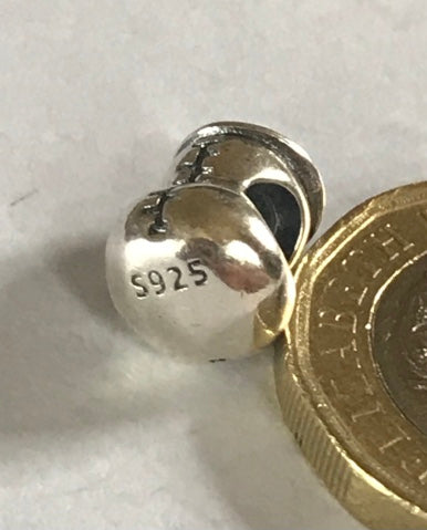 Silver Baby Bottle charm next to a gold coin on a white background for charm bracelet 925 silver