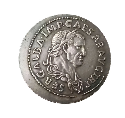 Ancient silver coin with engraved face and inscriptions on a white background