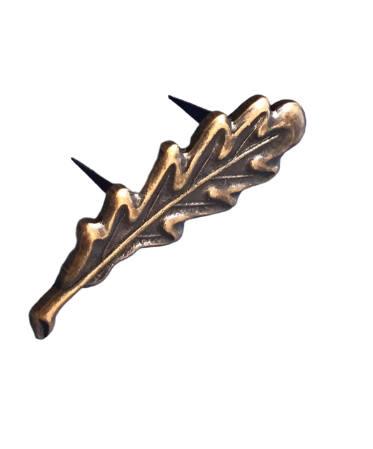 Decorative bronze leaf-shaped object on a white background