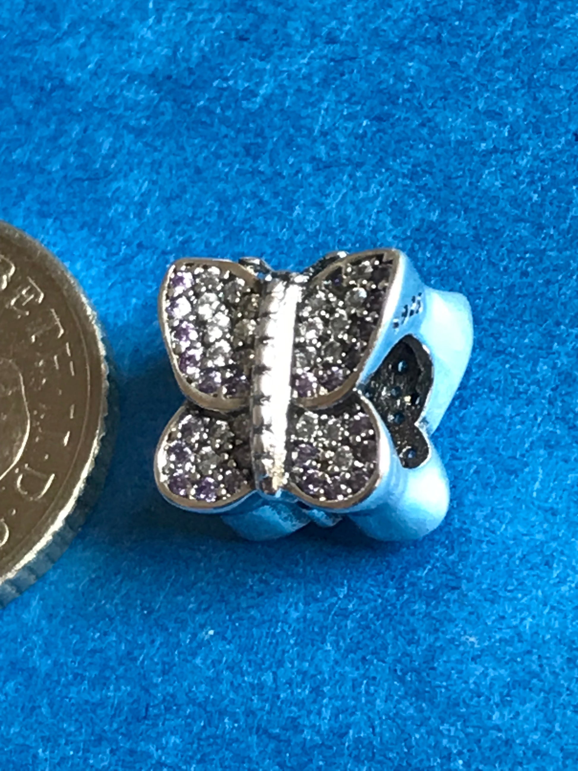 Butterfly-shaped charm with sparkling details on a blue background for charm bracelet 925 silver