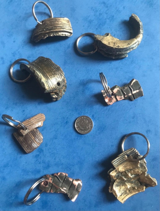 World War Two Battle of Britain Shrapnel key chains on a blue background