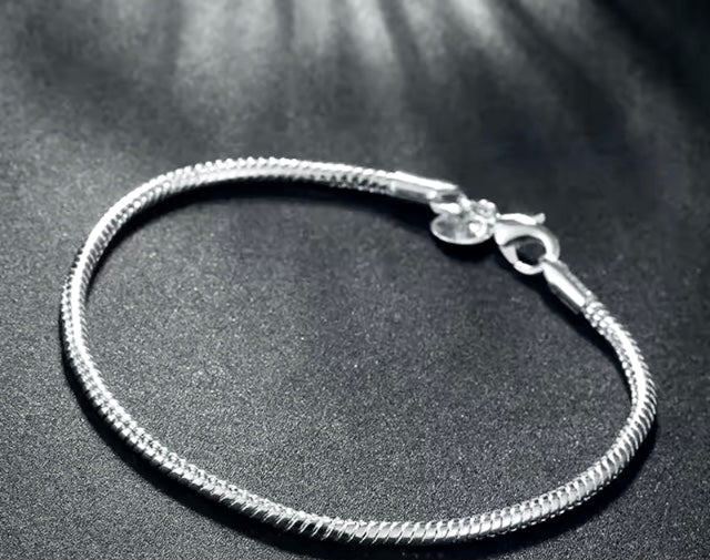 Silver bracelet on a dark textured surface