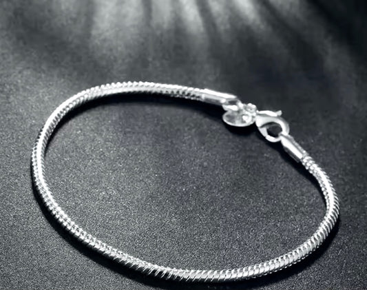 Silver bracelet on a dark textured surface