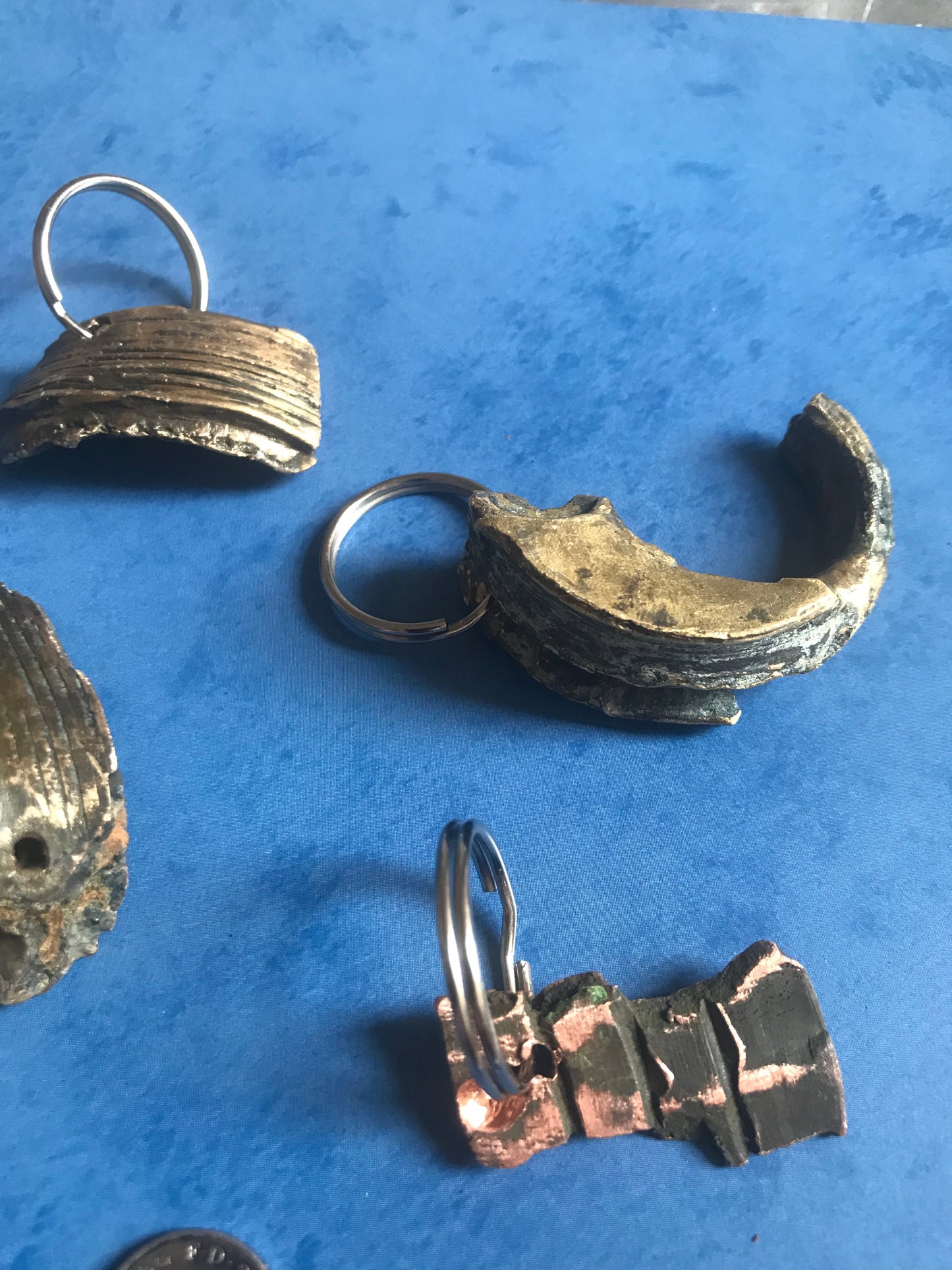 World War Two Battle of Britain Shrapnel key chains on a blue background