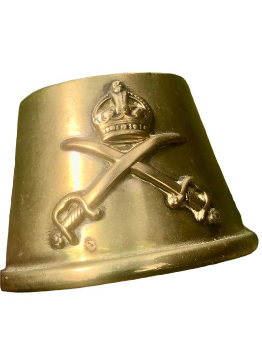 World War Two era Brass fuse cap made into a brass ashtray with cross swords on a white background