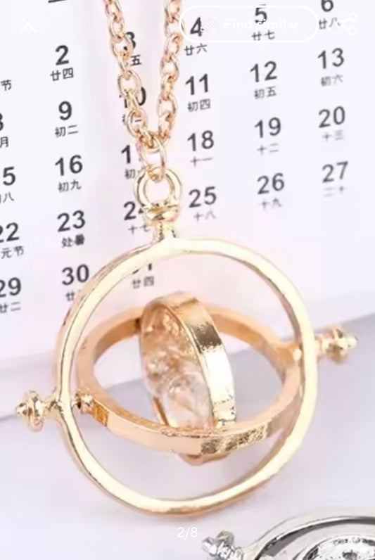 Harry Potter Time Turner necklace with a circular pendant on a calendar background
