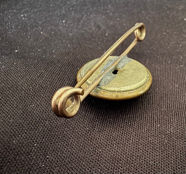 World War Two Trench Art Sweetheart Broach Brass Button on a brown fabric background