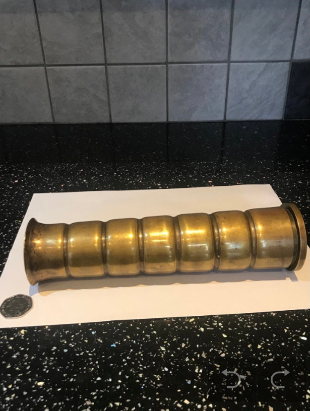 Brass World War Two Trench Art Vase on a kitchen work surface