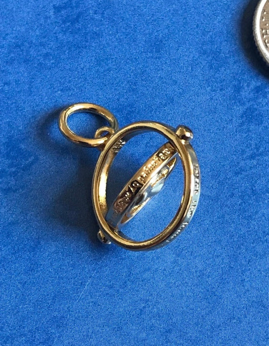 Genuine 925 Silver Time Turner charm with engraved text on a blue background