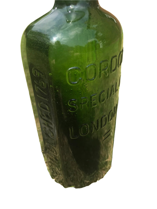 Gordon’s Special Dry London Gin Green Glass bottle with embossed text on a white background