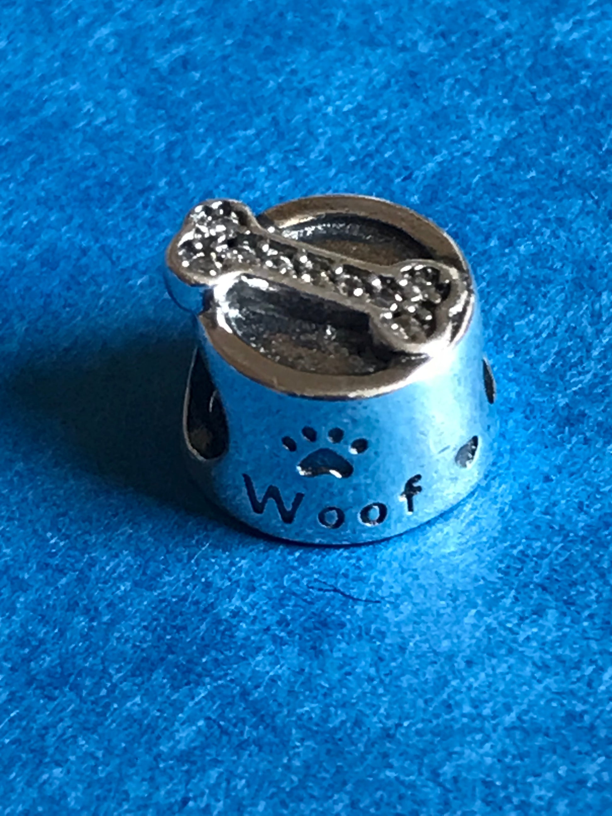 Silver charm with paw print and 'Woof' text on a blue background charm silver for charm bracelet 