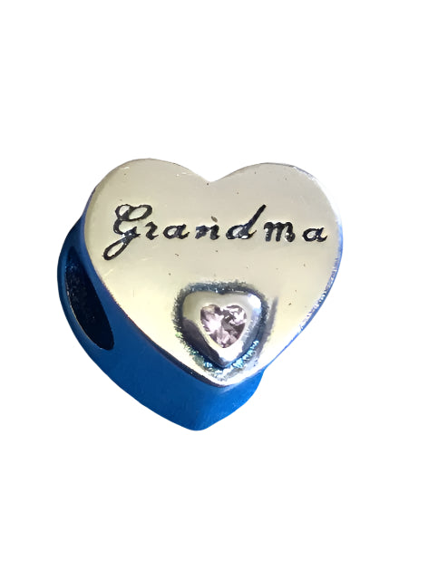 Heart-shaped charm with 'Grandma' engraving and a small pink gem on a white background