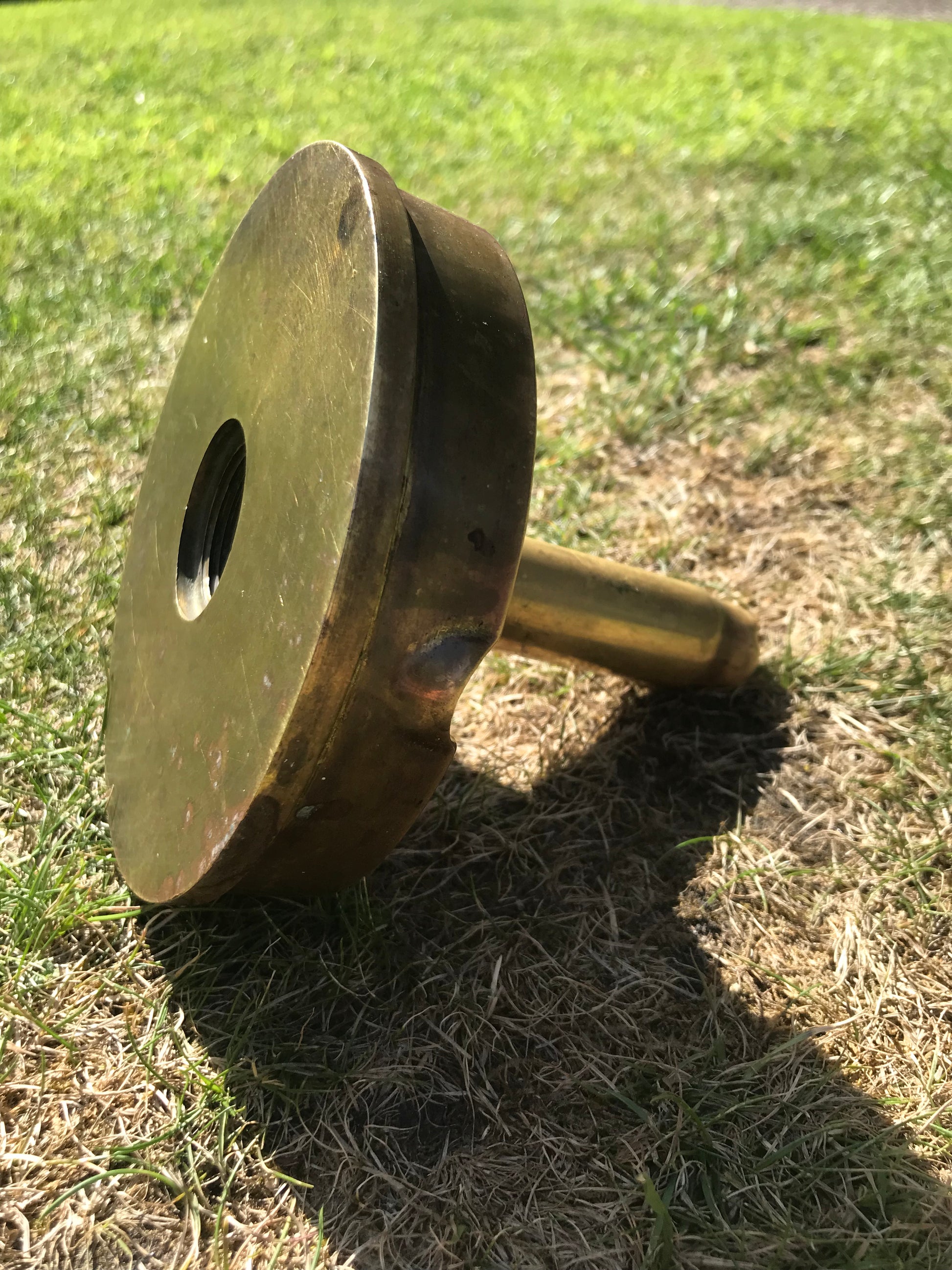 1945 dated trench art brass ashtray on grass