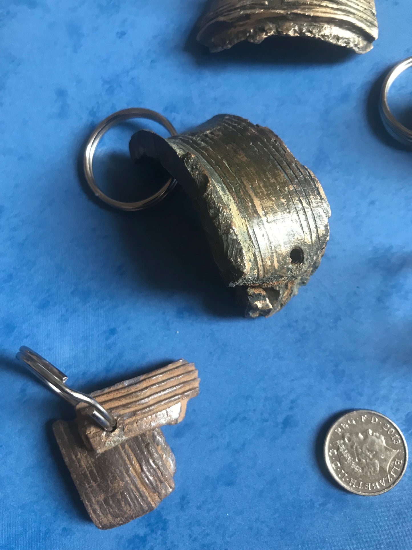 World War Two Battle of Britain Shrapnel key chains on a blue background