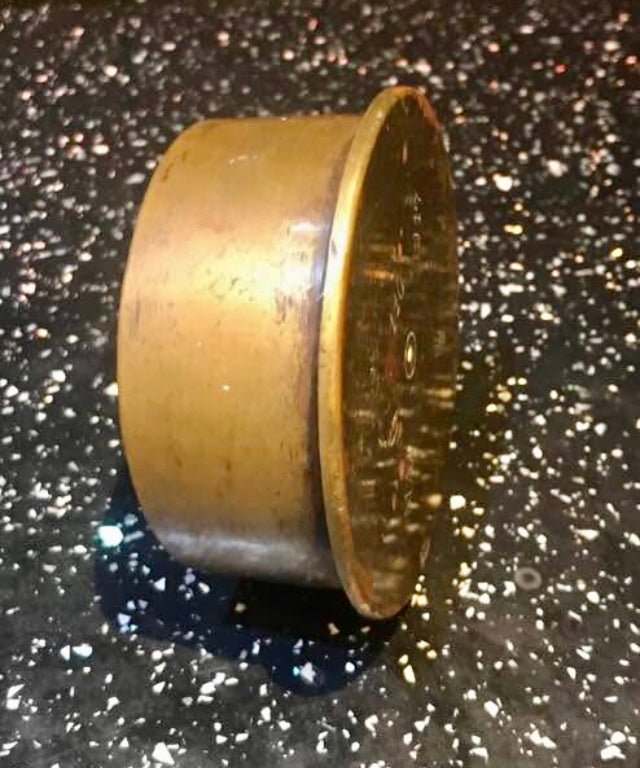 Brass WW1 Trench Art Ashtray on a dark speckled surface