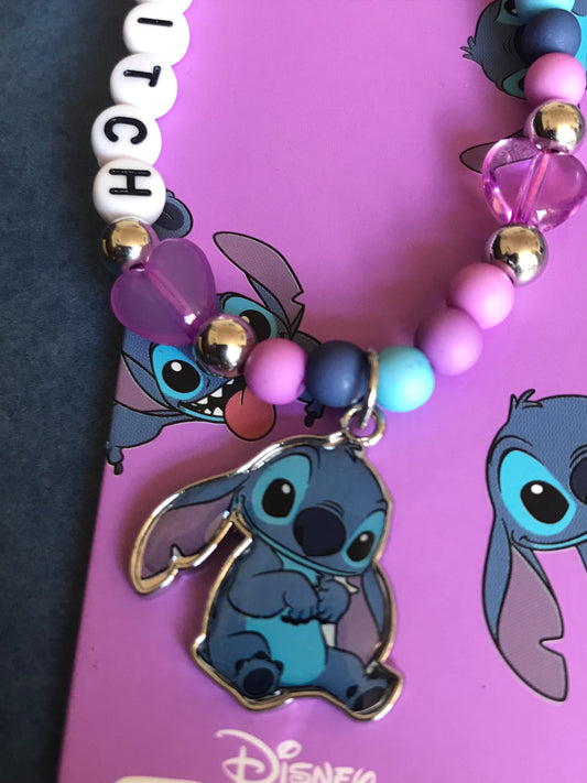 Lilo and Stitch phone Charm with colorful beads on a pink background