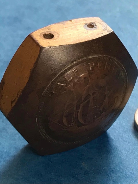 Hexagonal Vintage Genuine WW2 Trench Art 1942 brass lighter on a blue background