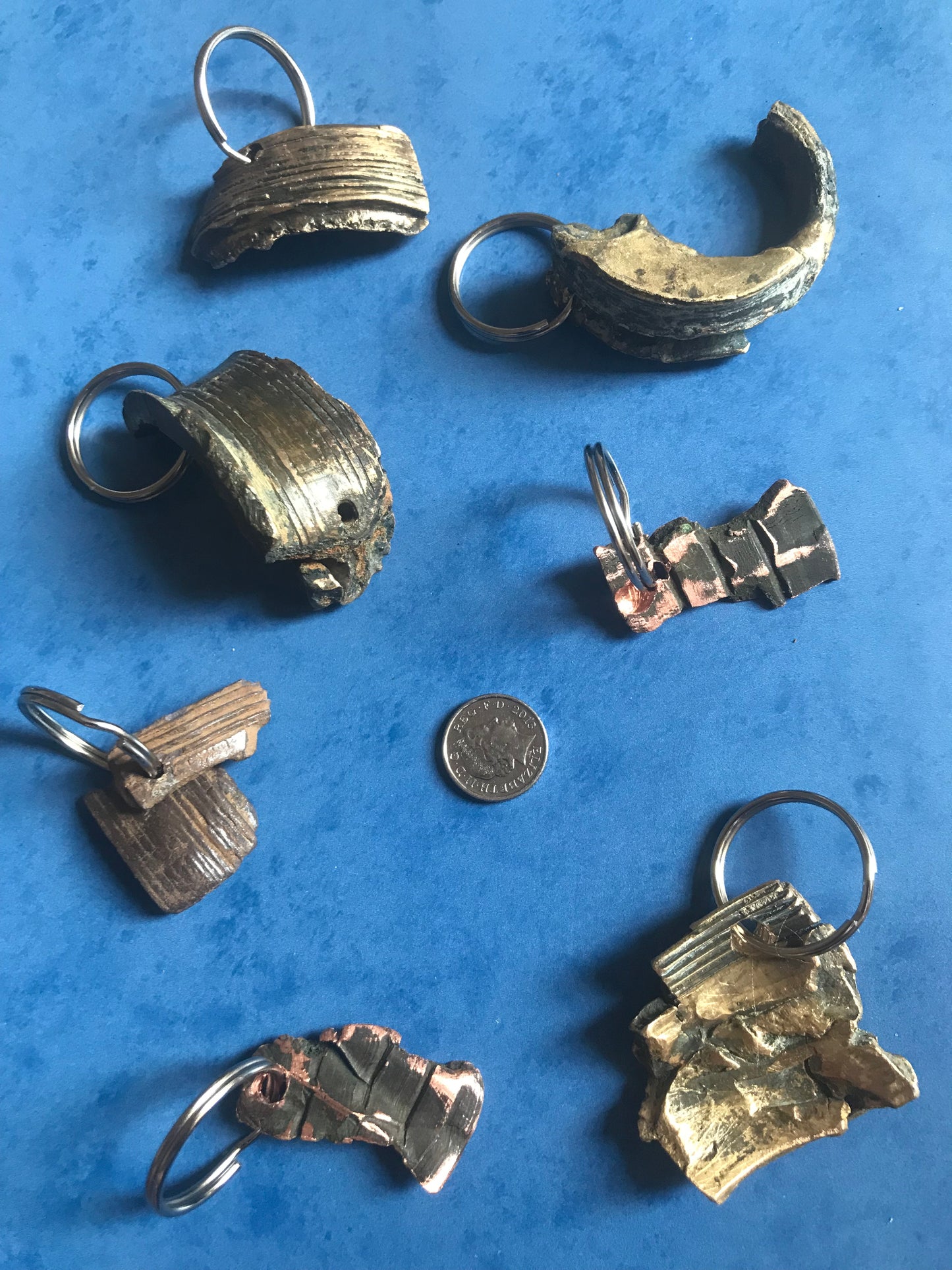 World War Two Battle of Britain Shrapnel key chains on a blue background