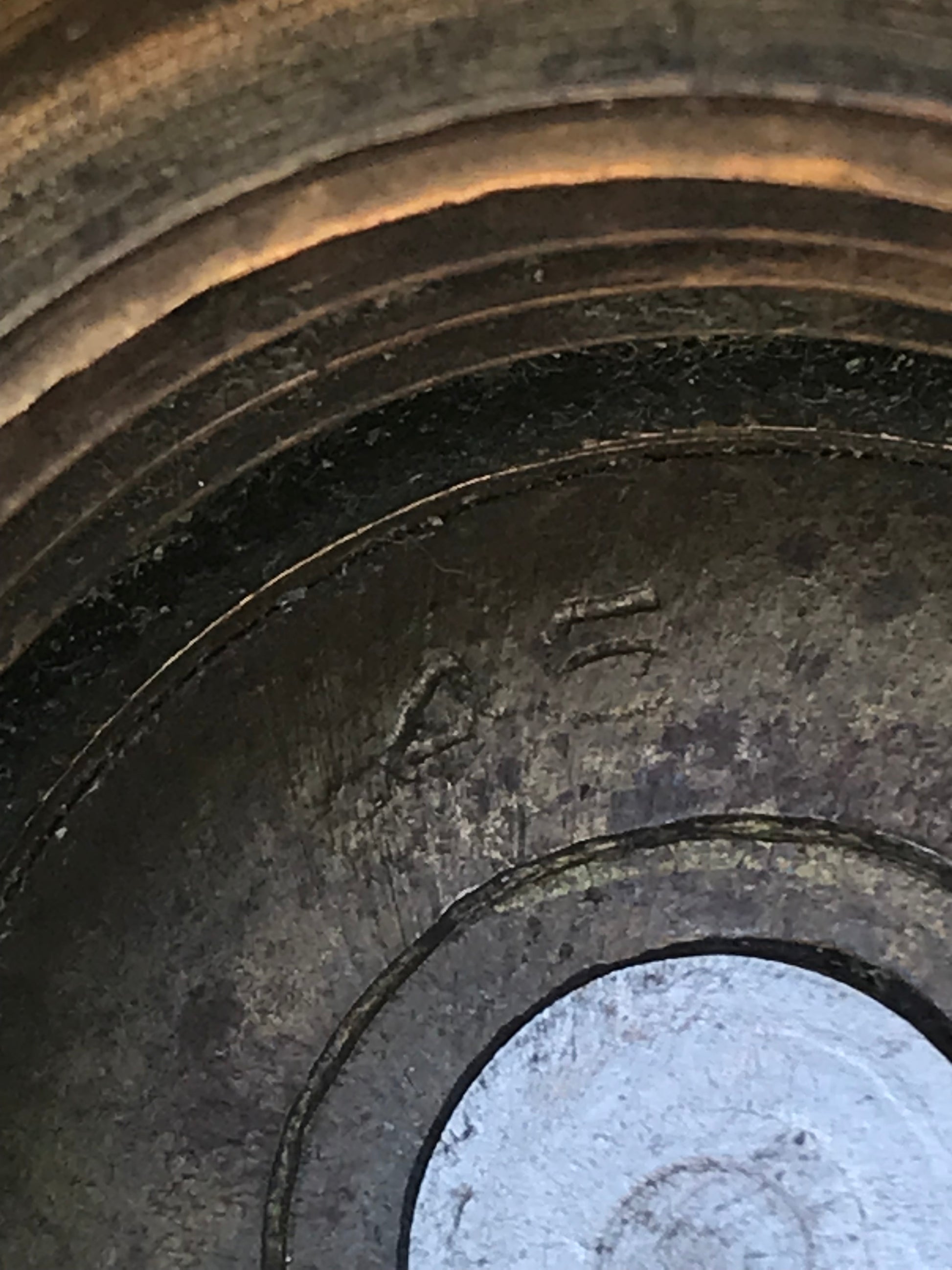 Close-up view of a 1945 dated trench art brass ashtray