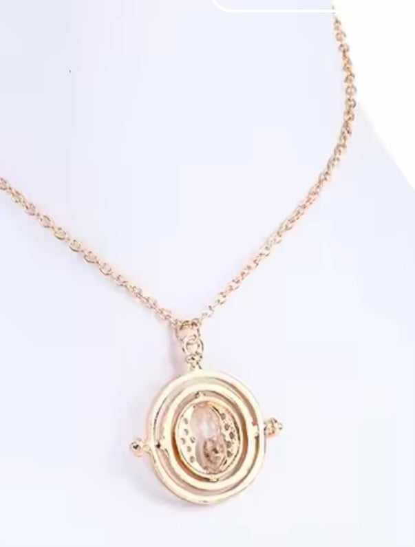 Harry Potter Time Turner Gold necklace with a circular pendant on a white background