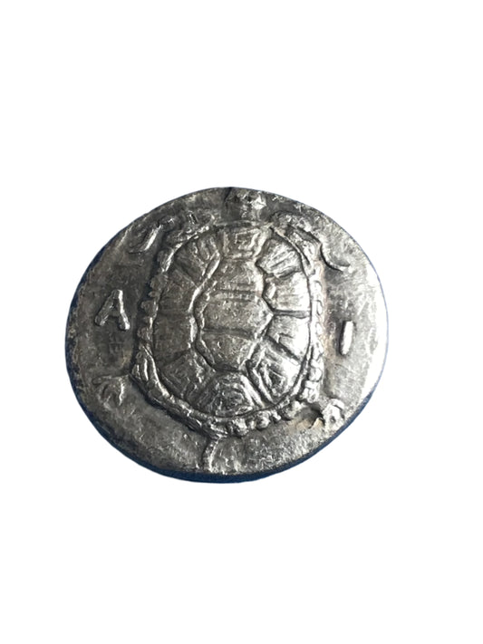 Silver coin with embossed design on a white background