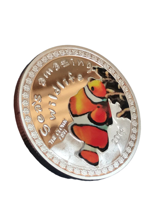 Coin with a clownfish design on a blue background