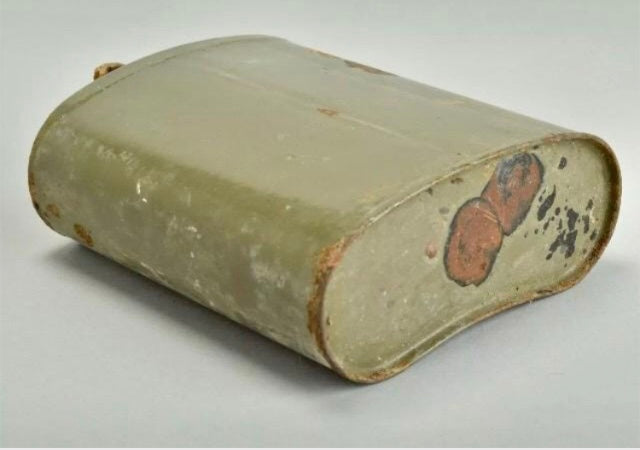 WW2 British Army Water Bottle with a light green color and brownish spots on a white background