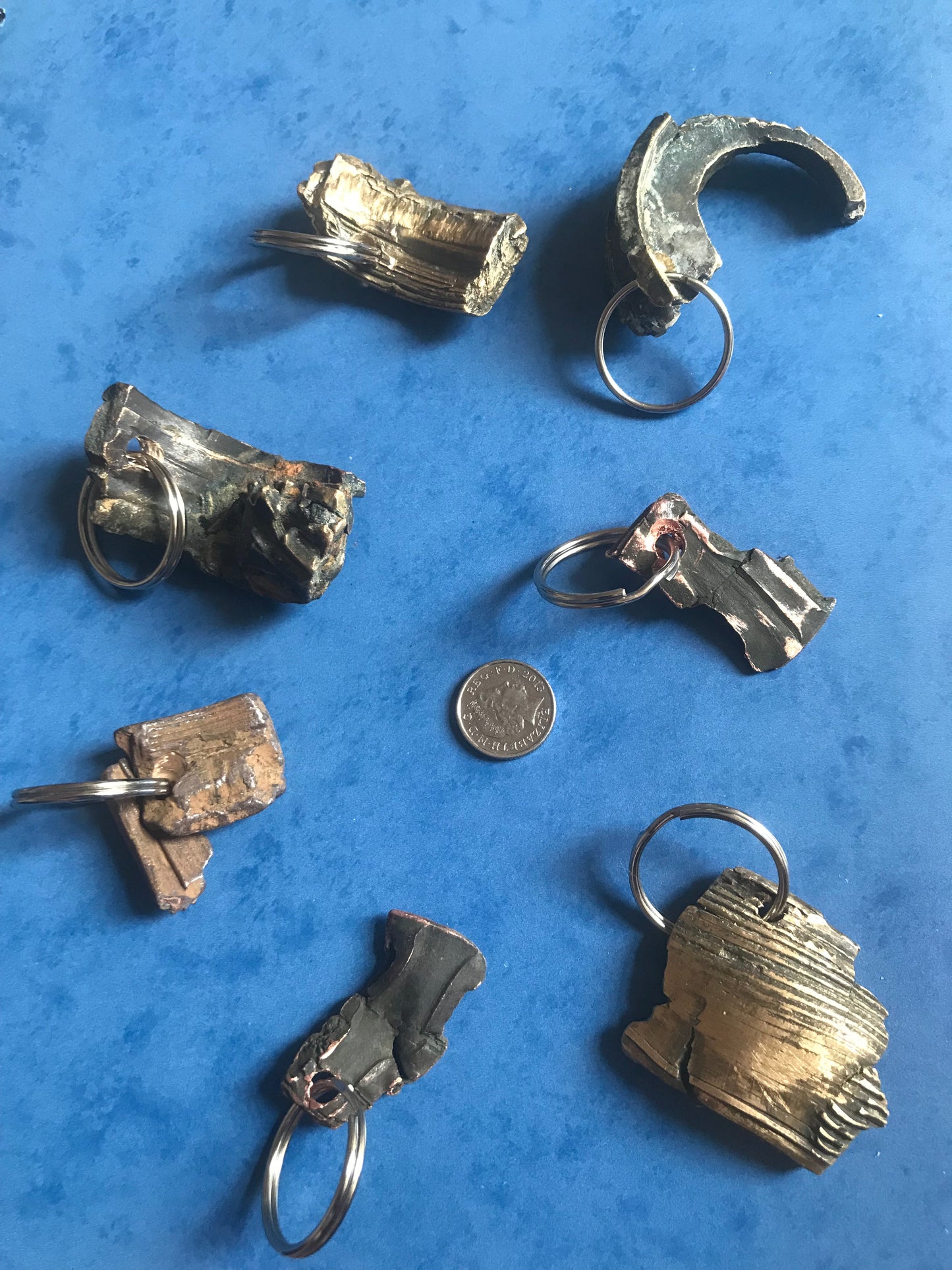 World War Two Battle of Britain Shrapnel key chains on a blue background
