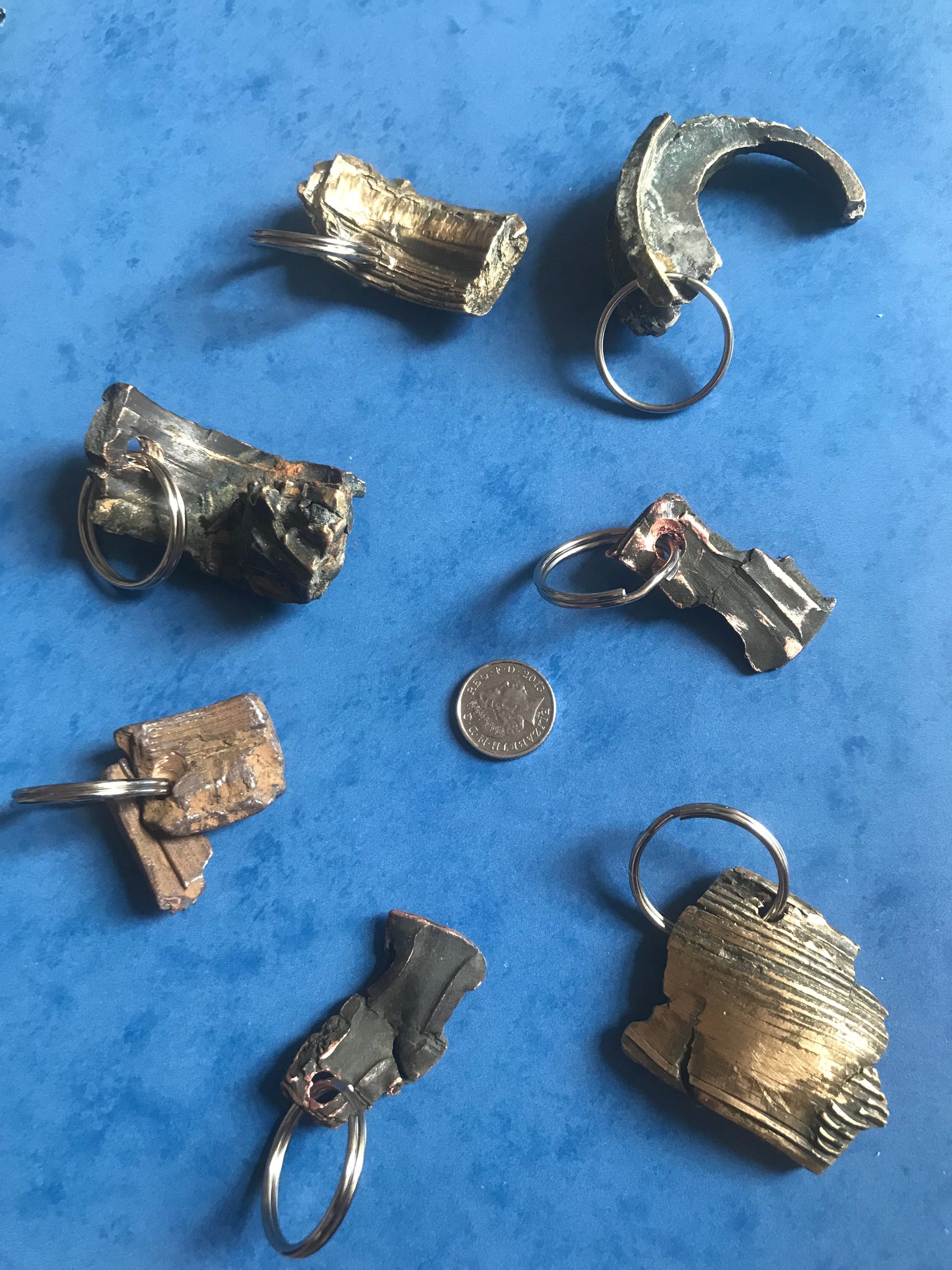 World War Two Battle of Britain Shrapnel key chains on a blue background