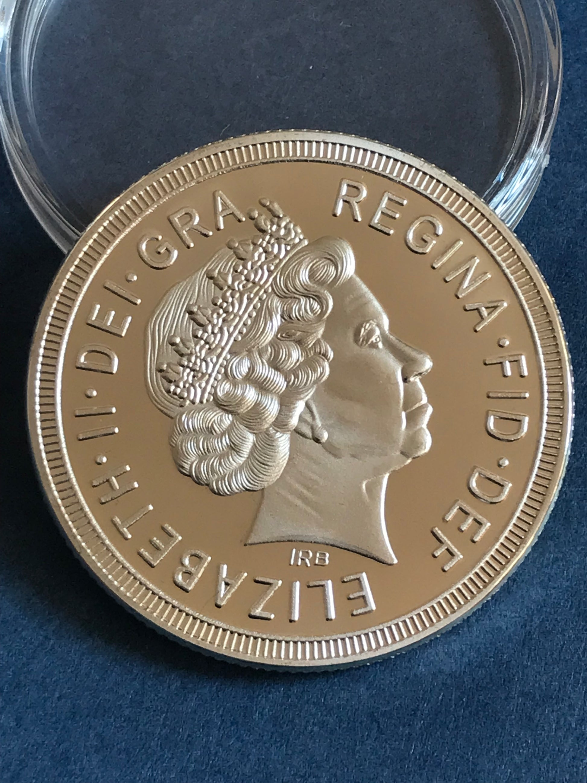 Gold coin with engraved design on a blue background
