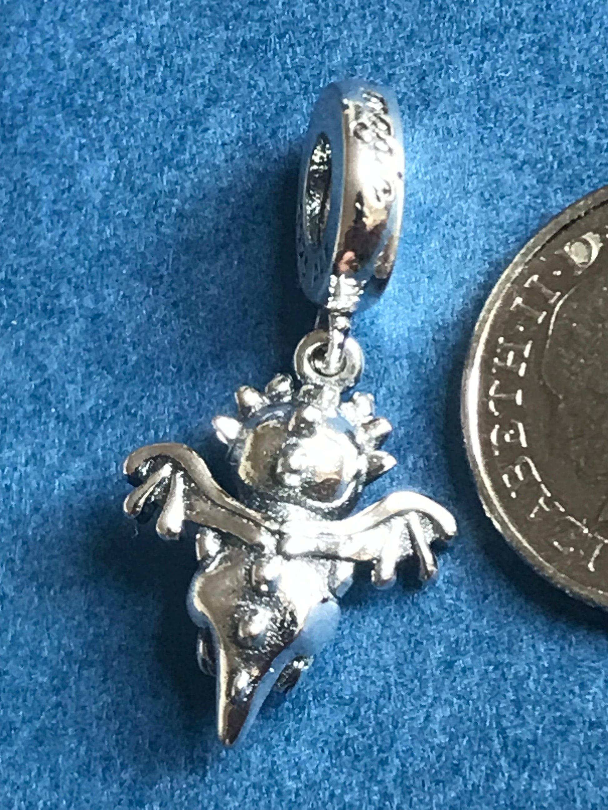 Genuine 925 Silver Dragon charm on a blue background