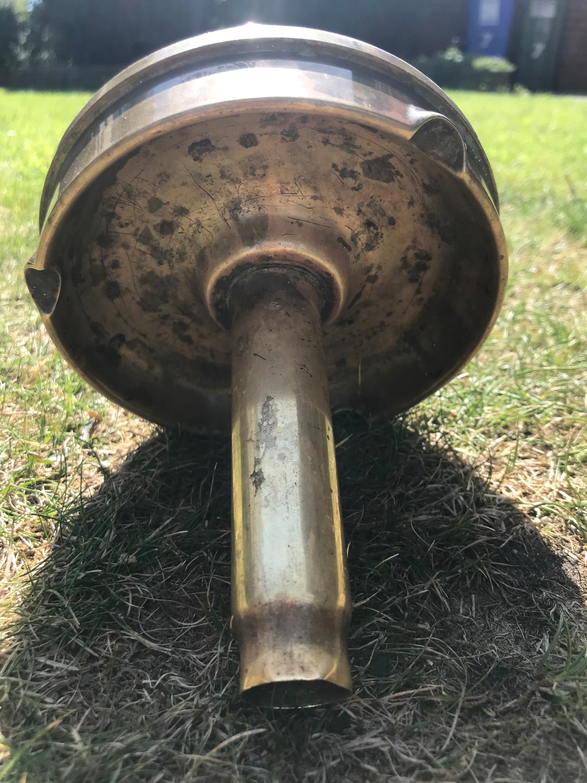 1945 dated trench art brass ashtray on grass