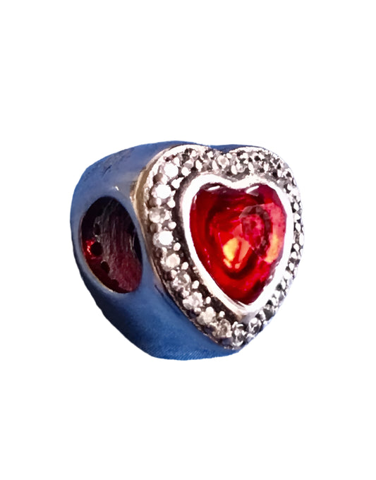 Heart-shaped charm with red center with silver sparkle